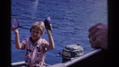 California (1955): Two Young Boys Standing Waist Deep In The Water Holding Up Two