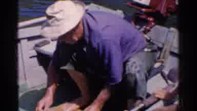 California (1955): Man White White Hat And Blue Shirt Using His Hammer On The
