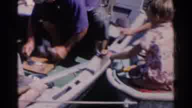 California (1955): People Boating On A Lake Preparing Food While Enjoying The Sun