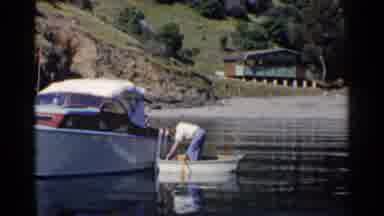 California (1955): Man On Boat Collecting A Object From Woman On Motorboat