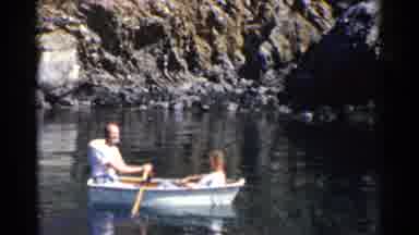 California (1955): Two Men Rowing White Boat Along Water Ocean River Rocks In The