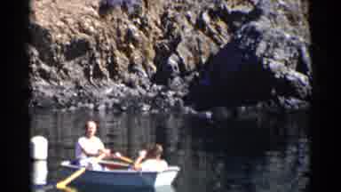 California (1955): Man Rows Boat In A Lake Near The Cliff side With Another Man In