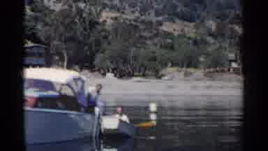 California (1955): Man Leaving A Big Boat To Get Onto A Smaller Boat And A Large