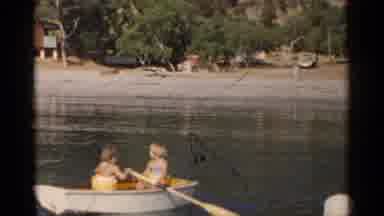 California (1955): Children Paddling A Boat In The Summer On A Lake