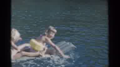 California (1955): Two Kids Sitting On Transparent Raft Float On A Bright Sunny