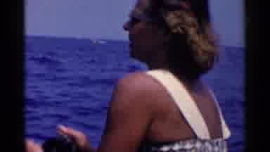 California (1955): A Woman In A Rolling Boat Is Fishing In The Middle Of Ocean