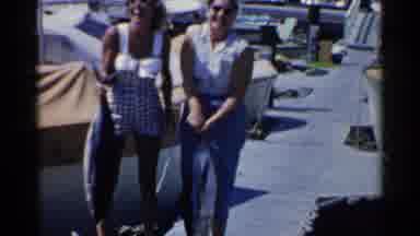 California (1955): Two Women Smiling On The Ship Dock While Holding Tuna Fishes