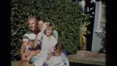 California (1955): Family Of Four With Dog Waves At Camera On A Sunny Day
