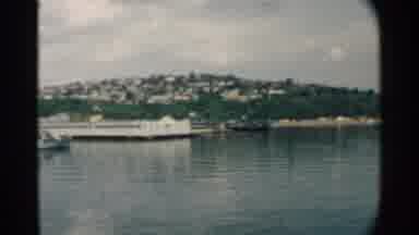 Pearl Harbor Hawaii (1958): Behind A Waterway Filled With Boats And A Pier A City