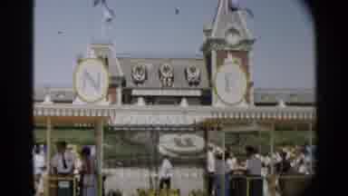 Disneyland-1959: Women Wearing Blue Dresses Standing Near Entrance To Disneyland