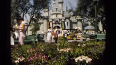 Disneyland-1959: Child Rides In Red Car With Woman On Amusement Park Track