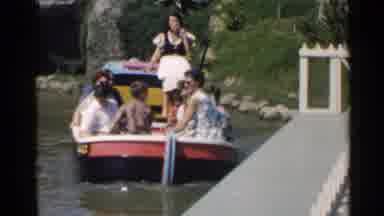 Disneyland (1959): Woman Wearing White Shirt Rides In White Boat Ride On A Bright