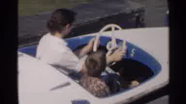 Disneyland-1959: Woman And Child Riding In Boat Under Bridge While Train Passes