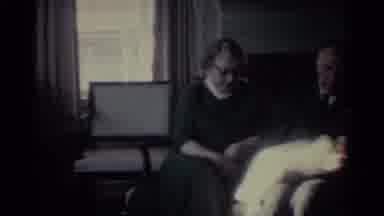 Ohio USA (1959): Older Man And Woman Sitting On A Loveseat Holding A Tiny Newborn