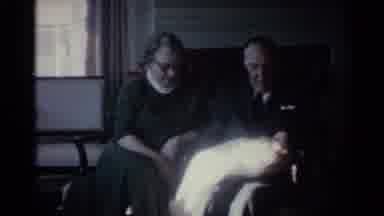 Ohio USA (1959): Older Man And Woman Sitting On A Loveseat Holding A Tiny Newborn