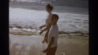 San Francisco (1959): Two Heterosexual People Walking Along The Beach At Sunset It