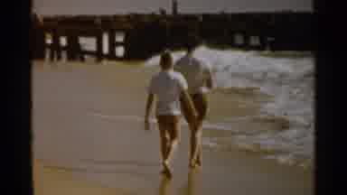 San Francisco (1959): Two People Walking On The Beach Near A Pier