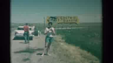 South Dakota (1959): A Woman With A Camera Takes A Picture And Then Walks Toward