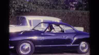 Germany-1961: Driving A Classic Purple Volkswagen Karmann Ghia On A Sunny Day