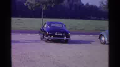 Germany-1961: Man In Classic Car Driving Away While Waving To Camera