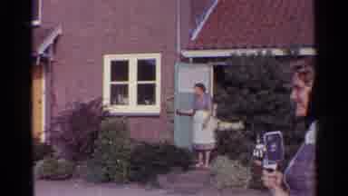 Germany-1961: Woman at House Doorway Filming with Super 8 Camera and Blue Karmann Ghia