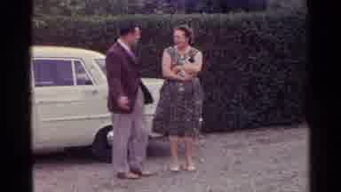 Germany (1961): Guy In Red Jacket And Women In Dress Talking And Laughing