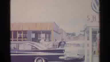 Germany (1961): Two Families Have A Conversation At A Gas Station
