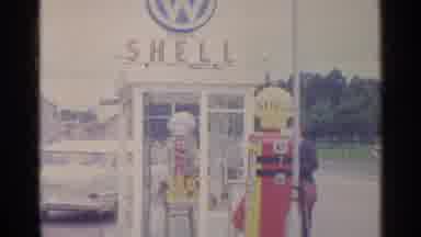 Germany (1961): A Man Walking Into A Phone Booth At A Shell Gas Station