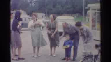 Germany (1961): People Standing At Roadside Waiting For Transportation In Late