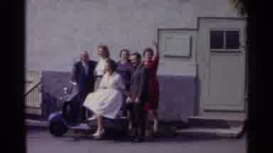 Germany (1961): In Front Of A Building A Group Of Well-Dressed People Pose Wave