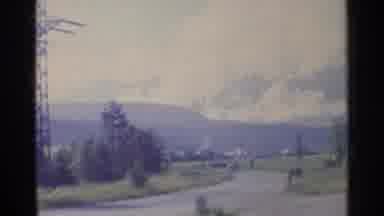 Germany (1961): Car Racing Down A Road With A Large Mountain In The Background