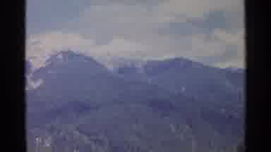 Germany (1961): Panning Shot Of Mountain Cape Covered In Snow Surrounded By Forest