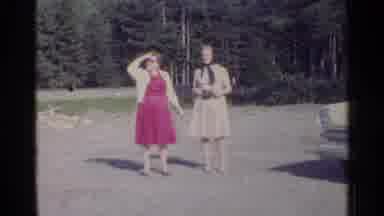 Germany (1961): Two Women Stand Outside Together Followed By Short Clips Of Homes