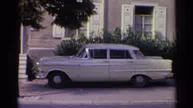 Germany (1961): A Vintage White Car Is Parked Outside A House In A Pretty