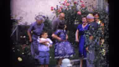 Germany (1961): People Standing In Front Of Pink Flowers For Picture On A Clear