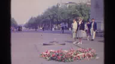 Paris France (1961): Women Wearing Grey Skirts Look At Grey Memorial On A Clear