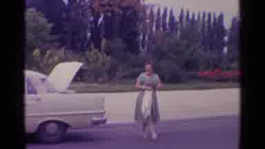 Paris France (1961): Woman Walking Towards Grey Sculpture On A Clear Day