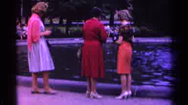 SWITZERLAND-1961: Three Women Conversing By The Pond In 1960s Fashion