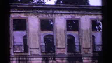 SWITZERLAND-1961: Camera Focusing On Ornate Palace Ruins With Statues