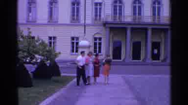 SWITZERLAND-1961: Three Women And One Man Standing In Front Of Building