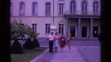 Switzerland (1961): Three Women And A Man Walk Down The Sidewalk Away From A
