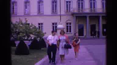 Switzerland (1961): Statue Of Man By Building Manicured Shrubs People!E Walking