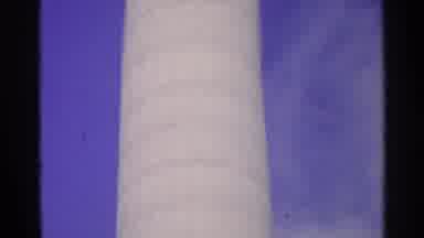 Switzerland (1961): Rising Tall Cylindrical Structure Against Blue Sky And Clouds