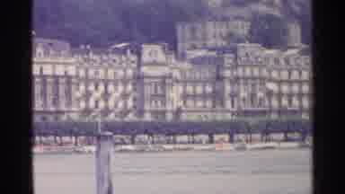 Switzerland (1961): Panning Large Buildings In Distance Behind Lake And Hedges