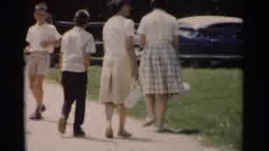 Jamestown Virginia (1962): Two Women In Skirts And Blouses Walk Alongside A Young