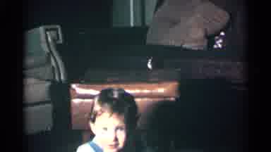 Kentucky USA (1963): Little Child Is Smiling At The Camera Inside Sitting In A