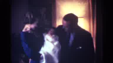 Kentucky USA (1963): A Happy Family Gathered Together Holding A Baby As They Smile