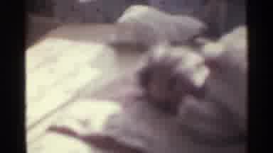 Kentucky USA (1963): A Baby Is Laying Down In A Blurry Shot And Someone Is Holding