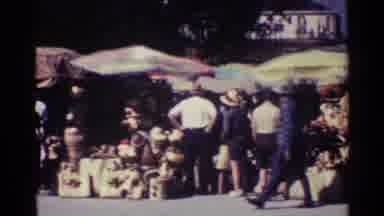 Nassau Bahamas (1963): People Shop Alongside The Street For Wares Under Large