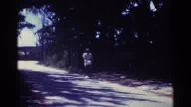 Nassau Bahamas (1963): Person With A Hat Riding A Bicycle On A Rural Road